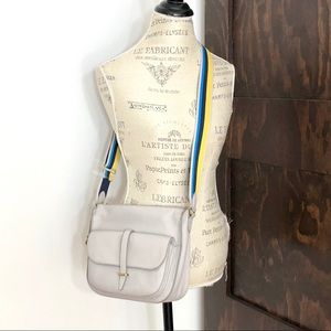 Fossil Gray Crossbody Bag with Blue and Yellow Strap